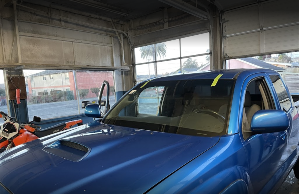 Pacific Coast Auto Glass Arcata CA blue truck inside shop