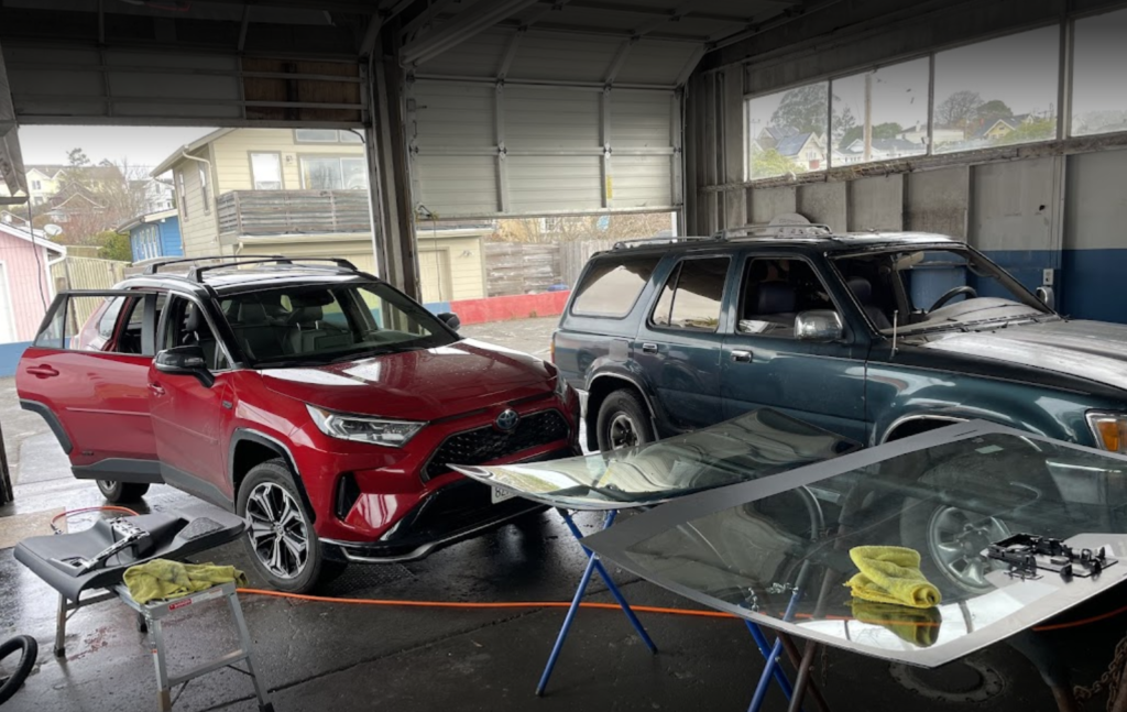 Pacific Coast Auto Glass Arcata CA blue and red truck inside shop